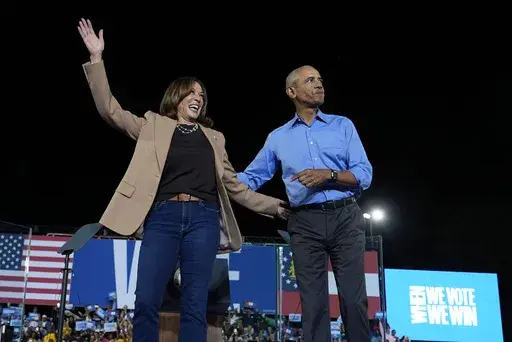 Democratic presidential nominee Vice President Kamala Harris waves with former President Barack Obama at a campaign rally at James R. Hallford Stadium, Thursday, Oct. 24, 2024, in Clarkston, Ga. (AP Photo/Julia Demaree Nikhinson)