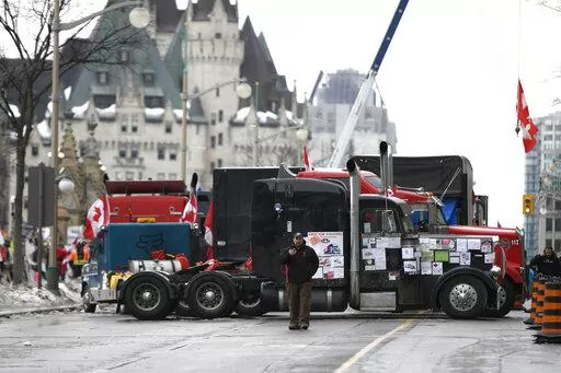 Trucks, are parked in front of the Chateau Laurier as a protest against COVID-19 restrictions continue in Ottawa, Thursday, Feb. 10, 2022.  (Justin Tang /The Canadian Press via AP)