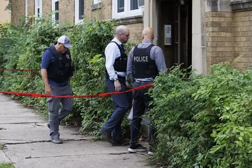CORRECTS AGE TO 9 Police investigate the apartment building of the shooter at the scene where an 9-year-old Chicago girl was killed in Portage Park, Sunday, Aug. 6, 2023. (Anthony Vazquez/Chicago Sun-Times via AP)