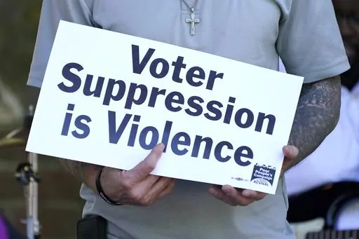 A person previously convicted of a felony felon holds a sign about voter suppression during a Poor People's Campaign assembly in Jackson, Miss., on Monday, April 19, 2021. The demonstrator was among speakers who called for Mississippi to simplify the way it restores voting rights to people convicted of some felonies. On Friday, June 30, 2023, the U.S. Supreme Court said it would not consider a case challenging Mississippi's practice of removing voting rights from people convicted of some crimes.