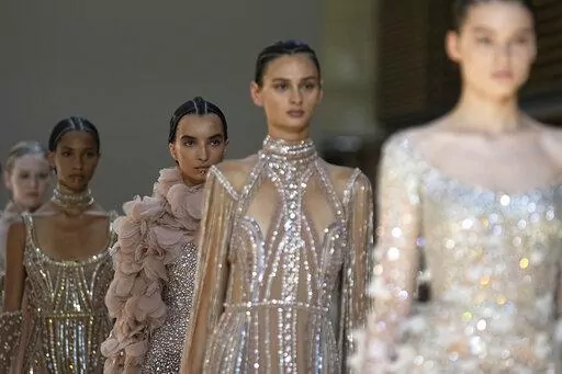 Models wear creations as part of Elie Saab's Haute Couture Fall/Winter 2022-2023 fashion collection presented Wednesday, July 6, 2022 in Paris. (AP Photo/Michel Euler)