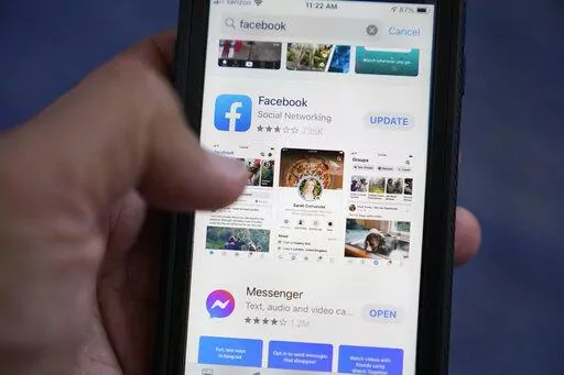 The Facebook app is shown on a smart phone, Friday, April 23, 2021, in Surfside, Fla. As you look through your social media feeds this summer, fear of missing out, or FOMO, can kick in when it seems like everyone you know is strolling through Paris or lounging on a tropical beach.    (AP Photo/Wilfredo Lee)