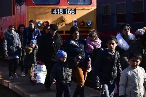 Refugees fleeing conflict from neighboring Ukraine arrive to Zahony, Hungary, Sunday, Feb. 27, 2022. As hundreds of thousands of Ukrainians seek refuge in neighboring countries, cradling children in one arm and clutching belongings in the other, leaders in Poland, Hungary, Bulgaria, Moldova and Romania are offering a hearty welcome. (AP Photo/Anna Szilagyi, File)