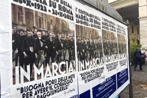 Posters commemorating the 100th anniversary of the March on Rome bearing a picture of Italian Fascist Dictator Benito Mussolini reading: "Marching!" with a quote by Mussolini "you have to set yourself goals to have the courage to reach them" are posted on the Rome's public billboard space, Thursday, Oct. 27, 2022. The posters were later ordered removed by Rome's Mayor Roberto Gualtieri. (AP Photo/Gregorio Borgia)