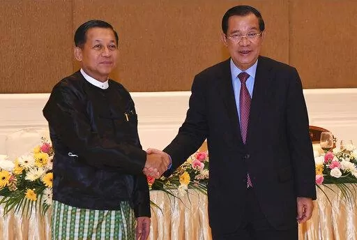 In this photo provided by An Khoun Sam Aun/National Television of Cambodia, Cambodian Prime Minister Hun Sen, right, shakes hands with Myanmar State Administration Council Chairman, Senior General Min Aung Hlaing, left, during after a meeting in Naypyitaw, Myanmar, Friday Jan. 7, 2022. Cambodian Prime Minister Hun Sen's visit to Myanmar seeking to revive peace efforts after last year's military takeover has provoked an angry backlash among critics, who say he is legitimizing the army's seizure o