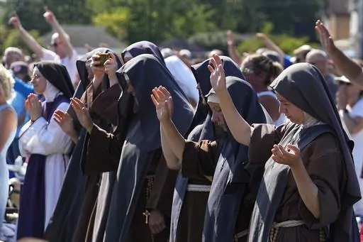 Attendees pray during a "rosary rally" on Sunday, Aug. 6, 2023, in Norwood, Ohio. On Nov. 7, Ohio voters approved a constitutional amendment that ensures access to abortion. It was the seventh consecutive state where voters decided to protect abortion access since the U.S. Supreme Court overturned the constitutional right to abortion in June 2022. (AP Photo/Darron Cummings, File)
