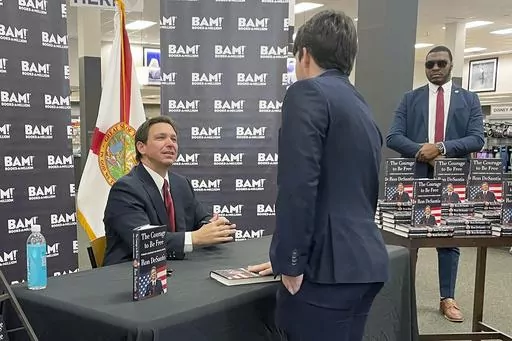 Florida Gov. Ron DeSantis greets supporters at a book signing event, Thursday, March 23, 2023 in Tallahassee, Fla. Allies of DeSantis are gaining confidence in his White House prospects as former President Donald Trump’s legal woes mount. Trump is facing possible criminal charges in New York, Georgia and Washington as he runs for president again. (AP Photo/Steve Peoples)