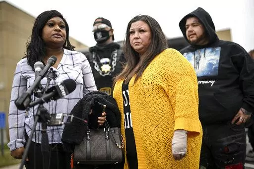 Katie Wright, center, stands beside activist Toshira Garraway and her son, Damik Bryant, during a news conference Thursday, May 5, 2022 outside the Brooklyn Center Police Station in Brooklyn Center, Minn. Katie Wright, the mother of Daunte Wright, said she was injured while she was briefly detained by one of the same department’s officers after she stopped to record an arrest of a person during a traffic stop.  (Aaron Lavinsky /Star Tribune via AP)