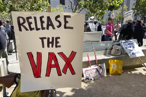 A sign urges the release of the monkeypox vaccine during a protest in San Francisco, July 18, 2022. The mayor of San Francisco announced a legal state of emergency Thursday, July 28, 2022, over the growing number of monkeypox cases. Public health officials warn that moves by rich countries to buy large quantities of monkeypox vaccine, while declining to share doses with Africa, could leave millions of people unprotected against a more dangerous version of the disease and risk continued spillover