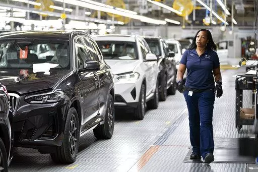 An employee works in the X3, X45 assembly hall at the BMW Spartanburg plant in Greer, S.C., Oct. 19, 2022. With inflation a top concern for voters, many Republican candidates are seeking to capitalize on Americans’ precarious financial situations heading into next week’s midterm elections to vilify a key component of President Joe Biden’s climate agenda: electric vehicles.  (AP Photo/Sean Rayford, File)