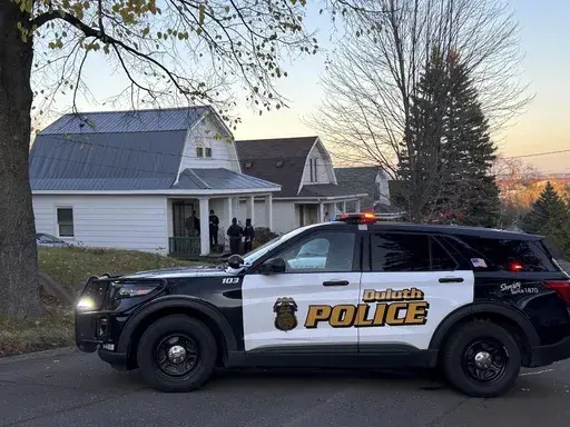 Police investigate the scene where five people were found shot to death inside two homes in Duluth, Minn., on Thursday, Nov. 7, 2024. (Christa Lawler/Star Tribune via AP)