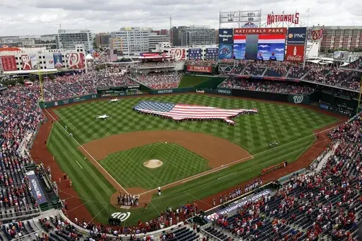 This July 4, 2013, file photo shows a U.S. flag, in the shape of the country, in the outfield before a baseball game between the Washington Nationals and the Milwaukee Brewers at Nationals Park in Washington. The attorney general for Washington, D.C. has sued StubHub, accusing the ticket resale platform of advertising deceptively low prices and then ramping up prices with extra fees. Attorney General Brian Schwalb said Wednesday the practice known as drip pricing violates consumer protection law
