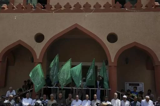 Hamas supporters and masked militants from the Izzedine al-Qassam Brigades, the military wing of Hamas, wave the green flags of the Islamist group during a protest in support of Palestinian prisoners in Israeli jails, after Friday prayer in Nusseirat refugee camp, central Gaza Strip, Friday, Aug. 18, 2023. It has become an Israeli mantra throughout the latest war in Gaza: Hamas is ISIS. Since the bloody Hamas attack on Oct. 7 that triggered the war, Israeli leaders and commanders have likened th