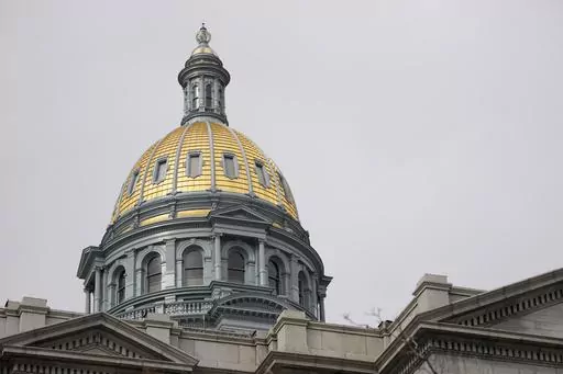 The gold dome of the Colorado State Capitol on March 23, 2023, in Denver. In Colorado, House lawmakers approved a measure Wednesday, April 12, that would lower the maximum interest rate for medical debt to 3%, require greater transparency in costs of treatment and prohibit debt collection during an appeals process. (AP Photo/David Zalubowski, File)