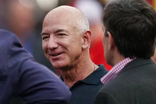 Amazon founder Jeff Bezos is seen on the sidelines before the start of an NFL football game, Sept. 15, 2022, in Kansas City, Mo. Bezos said in an interview with CNN that he will give away the majority of his wealth during his lifetime. The billionaire didn’t specify how - or to whom - he will give away the money, but said he and his girlfriend, Lauren Sanchez, were building the “capacity” to do it. Bezos has been criticized in the past for not pledging to donate the majority of his wealth 