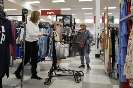 Customers shop at a retail store in Vernon Hills, Ill., Monday, June 12, 2023. The most-anticipated recession probably in modern U.S. history still hasn't arrived. Despite higher borrowing costs, thanks to the Federal Reserve's aggressive streak of interest rate hikes, consumers keep spending, and employers keep hiring. (AP Photo/Nam Y. Huh)
