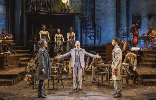 This image released by DKC/O&M shows Jon Jon Briones, center, and his daughter Isa Briones, left, and Jordan Fisher, right, and the cast during a performance of "Hadestown" in New York. (Evan Zimmerman for MurphyMade/DKC/O&M via AP)