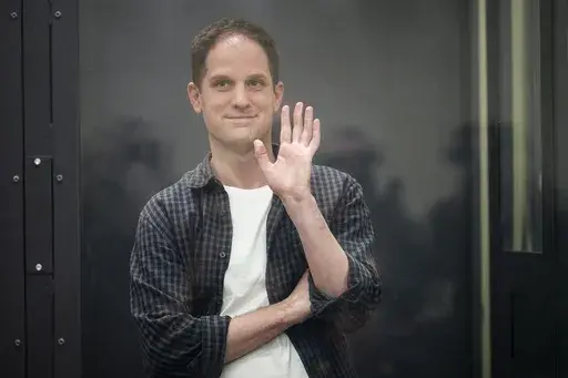 Wall Street Journal reporter Evan Gershkovich stands in a glass cage in a courtroom at the First Appeals Court of General Jurisdiction in Moscow, Russia, April 23, 2024. Gershkovich, who has been jailed for over a year in Russia on espionage charges, will stand trial in the city of Yekaterinburg, authorities said Thursday June 13, 2024. (AP Photo/Alexander Zemlianichenko, File)