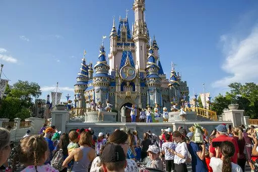 Performers dressed as Mickey Mouse, Minnie Mouse, Goofy, Donald Duck and Daisy Duck entertain visitors at Cinderella Castle at Walt Disney World Resort in Lake Buena Vista, Florida, on April 18, 2022. Last year was a roller coaster ride for theme parks and museums worldwide, with some places approaching pre-pandemic levels and others like parks in China struggling with lockdowns, according to a new report. (AP Photo/Ted Shaffrey, File)