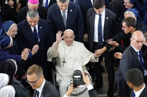 Pope Francis waves at the end of a meeting with priests, religious men and women, seminarians and catechists at the Our Lady Of Perpetual Help Cathedral in Nur-Sultan, Kazakhstan, Thursday, Sept. 15, 2022. Pope Francis is on the third day of his three-day trip to Kazakhstan. (AP Photo/Alexander Zemlianichenko)
