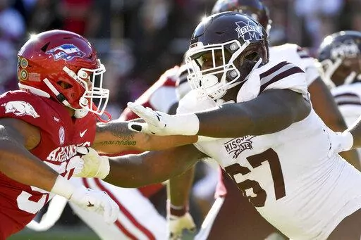 Mississippi State offensive lineman Charles Cross (67) blocks against Arkansas during an NCAA college football game Nov. 6, 2021, in Fayetteville, Ark. Cross was selected by the Seattle Seahawks during the first round of the NFL draft Thursday, April 28. (AP Photo/Michael Woods, File)
