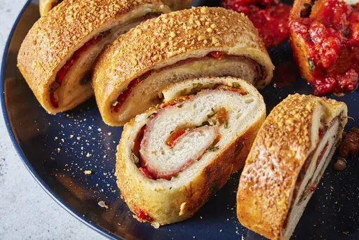 This image released by Milk Street shows a recipe for salami and cheese stromboli . (Milk Street via AP)