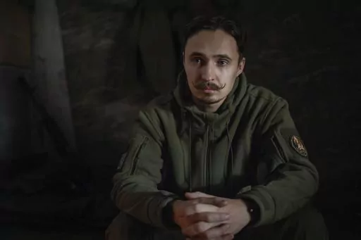 The serviceman of 47th brigade known by call-sign "Azimuth", 33, pauses, during an interview with The Associated Press, in Donetsk region, Ukraine, Thursday, Feb. 29, 2024. The loss of the city of Avdiivka last month marked the end of a long, exhausting defense for the Ukrainian military. One brigade had defended the same block of buildings for months without a break. (AP Photo/Alex Babenko)