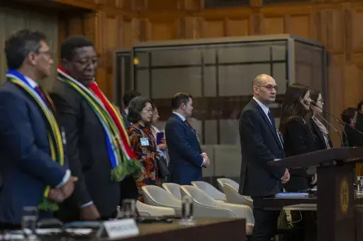 Front row from left, South Africa's agents Cornelius Scholtz, Vusimuzi Madonsela and Israel's agents Gilad Naom, Tamar Kaplan Tourgeman and co-agent Avigail Frisch Ben Avraham wait for the start of hearings at the International Court of Justice, in The Hague, Netherlands, Thursday, May 16, 2024. The U.N.'s top court opened two days of hearings in a case brought by South Africa to see whether Israel needs to take additional measures to alleviate the suffering in war-ravaged Gaza. (AP Photo/Peter 