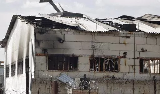 In this photo taken from video a view of a destroyed barrack at a prison in Olenivka, in an area controlled by Russian-backed separatist forces, eastern Ukraine, Friday, July 29, 2022. Russia and Ukraine accused each other Friday of shelling a prison in a separatist region of eastern Ukraine, an attack that reportedly killed dozens of Ukrainian military prisoners who were captured after the fall of a southern port city of Mariupol in May. (AP Photo)