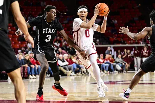 Oklahoma guard Jeremiah Fears (0) drives against Mississippi State forward KeShawn Murphy (3) during the second half of an NCAA college basketball game, Saturday, Feb. 22, 2025, in Norman, Okla. (AP Photo/Gerald Leong)