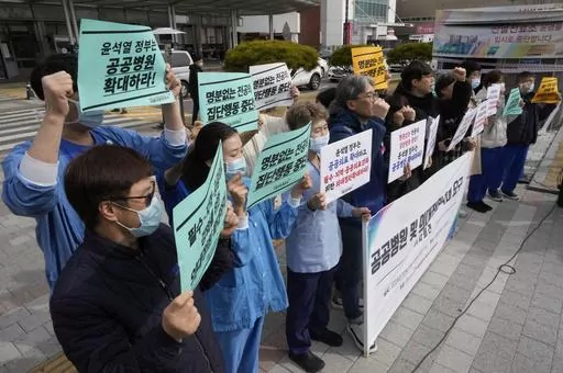 Members of The Korean Public Service and Transport Workers' Union stage a rally to demand expansion of public hospitals and medical students at the Seoul National University Hospital in Seoul, South Korea, Tuesday, Feb. 27, 2024. (AP Photo/Ahn Young-joon)