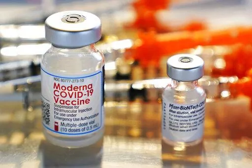 Vials for the Moderna and Pfizer COVID-19 vaccines are seen at a temporary clinic in Exeter, N.H. on Thursday, Feb. 25, 2021. The Food and Drug Administration has authorized another booster dose of the Pfizer or Moderna COVID-19 vaccine for people age 50 and up, Tuesday, March 29, 2022.   (AP Photo/Charles Krupa, File)
