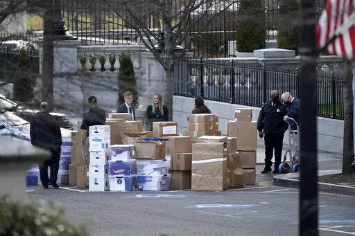 People wait for a moving van after boxes were moved out of the Eisenhower Executive Office building inside the White House complex, on Jan. 14, 2021, in Washington. A congressional oversight committee has sought additional documents from the National Archives related to former President Donald Trump's handling of White House records as the panel looks to expand its investigation into his handling of sensitive and even classified information. (AP Photo/Gerald Herbert, File)