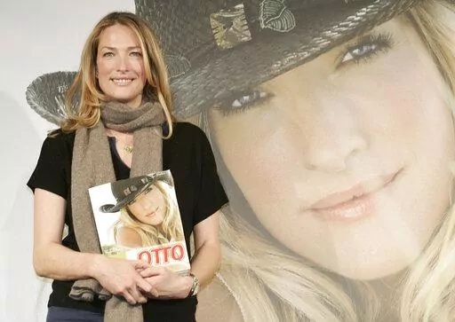 German model Tatjana Patitz poses with the new catalog of German catalog company Otto during a photocall in Hamburg, Germany, on Thursday, Dec. 14, 2006. Patitz, one of an elite group of famed supermodels who graced magazine covers in the 1980s and ’90s and appeared in George Michael's “Freedom! '90” music video, has died at age 56. (AP Photo/Fabian Bimmer, File)