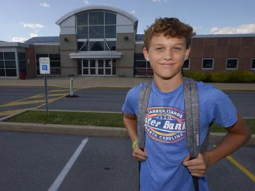 Braylon Price, 13, pauses on his way home from Bellefonte Middle School Wednesday, Aug. 31, 2022, in Bellefonte, Pa. The teenager was among more than 45,000 Pennsylvania students whose parents elected to take advantage of a new state pandemic-era law option of holding their child back a year in school. He repeated the sixth grade. (AP Photo/Gary M. Baranec)
