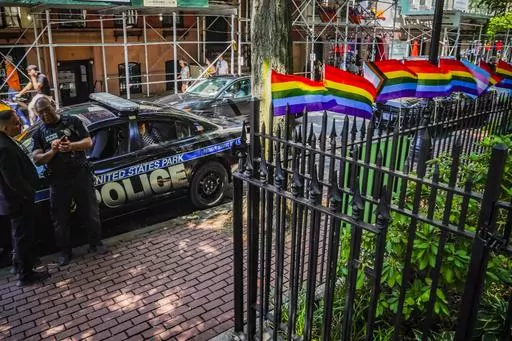 Pride flags, a symbol celebrating the LGBTQ+ community, decorate the fence at the Stonewall National Monument with U.S. Park police present, Tuesday, June 13, 2023, in New York. Dozens of LGBTQ+ Pride flags were damaged and ripped down at the monument over the weekend, the third such bout of vandalism during Pride Month at the LGBTQ+ landmark, police said. (AP Photo/Bebeto Matthews, File)
