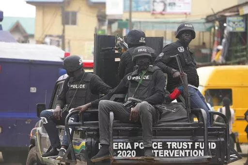 FILE- Police officers patrol during a protest by Nigeria Labour Congress on the street in Lagos, Nigeria, on July 26, 2022. Nigeria's police chief says hundreds of thousands of security forces are being deployed to ramp up safety in various troubled regions ahead of the country's Feb. 25 presidential election. More than 400,000 security personnel would be deployed for the vote in anticipation of challenges ranging from continued attacks by armed groups and suspected separatists targeting remote 