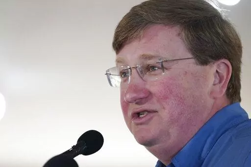 Republican Gov. Tate Reeves addresses the crowd at the pavilion in Founders Square at the Neshoba County Fair in Philadelphia, Miss., Thursday, July 28, 2022. The fair, also known as Mississippi's Giant House Party, is an annual event of agricultural, political, and social entertainment at what might be the country's largest campground fair. (AP Photo/Rogelio V. Solis)