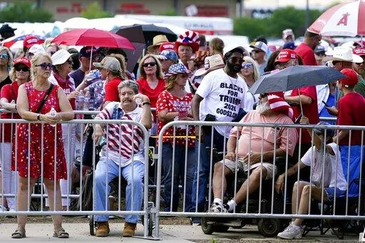 Supporters of former President Donald Trump wait in line hours before the former president is set to speak at a ally Friday, July 22, 2022, in Prescott, Ariz. (AP Photo/Ross D. Franklin)