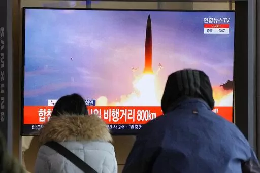 People watch a TV showing a file image of North Korea's missile launch during a news program at the Seoul Railway Station in Seoul, South Korea, Sunday, Jan. 30, 2022. North Korea on Sunday fired what appeared to be the most powerful missile it has tested since U.S. President Joe Biden took office, as it revives its old playbook in brinkmanship to wrest concessions from Washington and neighbors amid a prolonged stalemate in diplomacy. (AP Photo/Ahn Young-joon)
