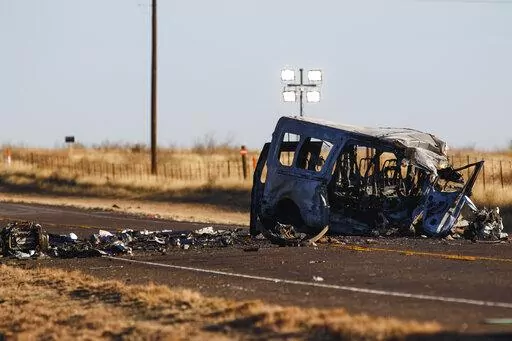 The damage bus sits on the side of the road at the scene of a fatal car wreck early Wednesday, March 16, 2022 half of a mile north of State Highway 115 on Farm-to-Market Road 1788 in Andrews County, Texas. A pickup truck crossed the center line of a two-lane road in Andrews County, about 30 miles (50 kilometers) east of the New Mexico state line on Tuesday evening and crashed into a van carrying members of the University of the Southwest men's and women's golf teams, said Sgt. Steven Blanco of t