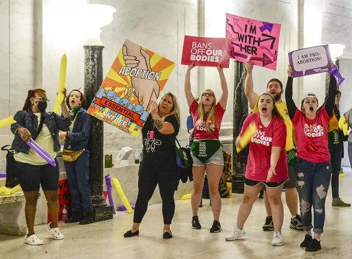Abortion rights supporters demonstrate outside the Senate chamber at the West Virginia state Capitol on Tuesday, Sept. 13, 2022, in Charleston, W.Va., as lawmakers debated a sweeping bill to ban abortion in the state with few exceptions. (Chris Dorst/Charleston Gazette-Mail via AP)