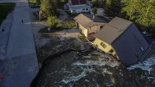 A house sits in Rock Creek after floodwaters washed away a road and a bridge in Red Lodge, Mont., Wednesday, June 15, 2022. After three nasty years, the La Nina weather phenomenon is gone, the National Oceanic and Atmospheric Administration said Thursday, March 9, 2023. (AP Photo/David Goldman, File)
