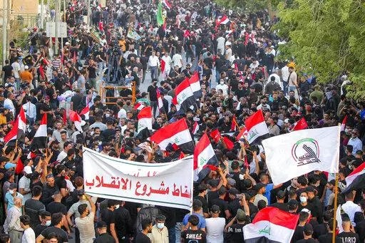 Supporters of Iran-backed Shiite Coordination Framework attend a rally to denounce their rivals, followers of an influential Shiite cleric Muqtada al-Sadr who stormed the parliament last month and have since been holding a sit-in outside the assembly building in Baghdad, Iraq, Friday, Aug. 12, 2022. (AP Photo/Anmar Khalil)