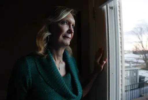 Christine Zuba, who came out as a transgender woman at age 58, stands for a portrait at her home in Blackwood, N.J., on Monday, Feb. 14, 2022. (AP Photo/Jessie Wardarski, File)