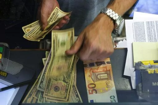 A cashier changes a 50 Euro banknote with US dollars at an exchange counter in Rome, Wednesday, July 13, 2022. Inflation for the European countries using the euro currency hit another record in August, fuelled by soaring energy prices mainly driven by Russia’s war in Ukraine. Annual inflation in the eurozone’s 19 countries rose to 9.1% in August, up from 8.9% recorded in July. That's according to the latest figures released Wednesday, Aug. 31, 2022 by the European Union statistics agency. (A