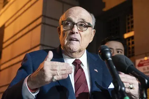 Former New York Mayor Rudy Giuliani talks to reporters as he leaves the federal courthouse in Washington, Dec. 11, 2023. A judge threw out Rudy Giuliani’s bankruptcy case on Friday, July 12, 2024, finding that the former New York City mayor had flouted the process with a lack of transparency. (AP Photo/Jose Luis Magana, File)