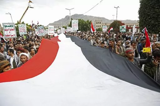 Houthi supporters chant slogans holding signs reading "Death to America, Death to Israel", as they attend a rally marking eight years for a Saudi-led coalition, Friday, March 26, 2023, in Sanaa, Yemen. For years, the Houthi rebels controlling northern Yemen have chanted slogans at their mass rallies calling for the destruction of Israel. But they never joined any conflict beyond the confines of their own country’s civil war or nearby in the Arabian Peninsula. The Iranian-backed Shiite Muslim f