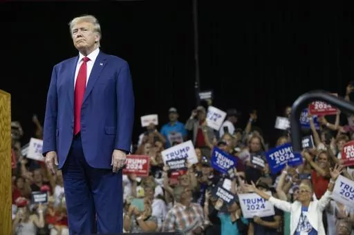 Former President Donald Trump stands as the crowd cheers at the South Dakota Republican Party Monumental Leaders rally Friday, Sept. 8, 2023, in Rapid City, S.D. (AP Photo/Toby Brusseau)