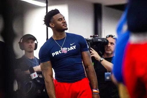 Liberty quarterback Malik Willis prepares the school's pro football day for NFL scouts and coaches, Tuesday, March 22, 2022, in Lynchburg, Va. (AP Photo/Kendall Warner)